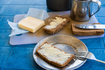 Bread with butter, set for a short breakfast. Simple rustic vegetarian food concept. Stock photo.