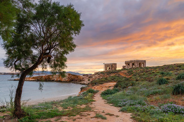 Beautiful sunset with amazing clouds over sea coast. Paros island in Greece