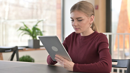 Young Woman Working on Tablet in Office