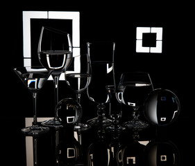 
Six glasses and glass balls on a black background