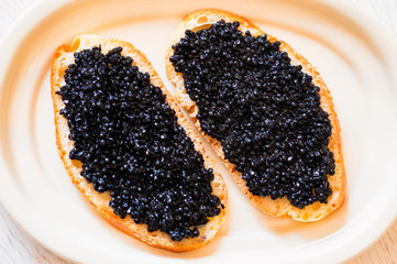 Sandwiches with black sturgeon or beluga caviar close up