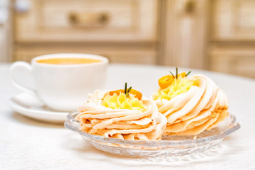 Meringue cake decorated with kumquat and coffee