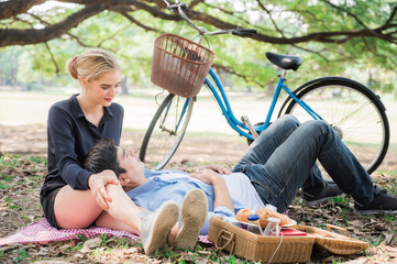 Young couple lovers in the park They come to picnic On a nice, pleasant day