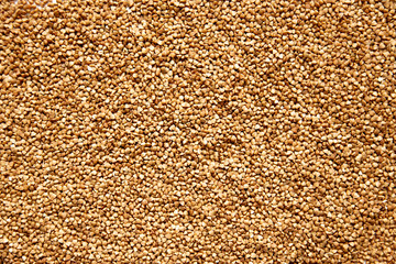 Brown background of buckwheat sprinkled on a table, foreshortening - from above. Concept - stocks before the covid-19 epidemic