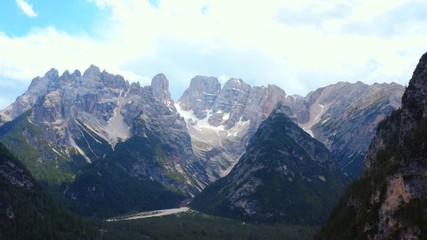 Fototapeta premium Dramatic scenery of high glorious mountain range on clear summer day Spectacular Alps mountain peaks covered by pine forest woods