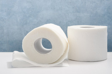 Rolls of white toilet paper close-up. Personal hygiene products.