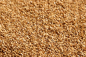 Brown background of buckwheat sprinkled on a table, foreshortening - from above. Concept - stocks before the covid-19 epidemic
