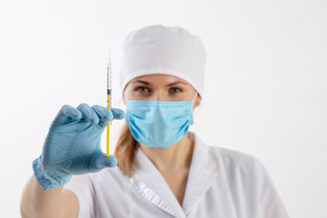 Doctor in a white coat holding a syringe.