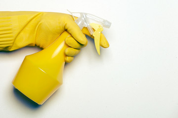 Spray gun in hand, yellow rubber glove