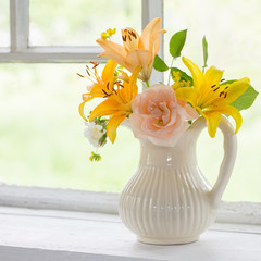 flowers in vase on windowsill