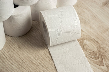 A roll of toilet paper on background of many rolls