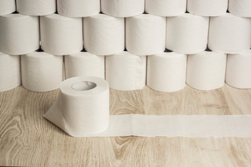 A roll of white toilet paper on background of many rolls