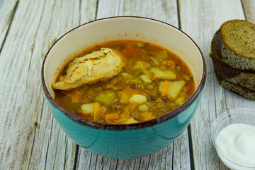 Lentil soup with chicken and sour cream with bread