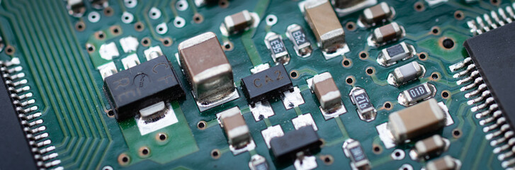 Electronics. Back of a traditional HDD details macro closeup chips resistors capacitors and other microelectronics printed circuit
