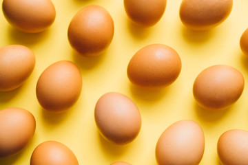 chicken eggs on yellow background easter concept