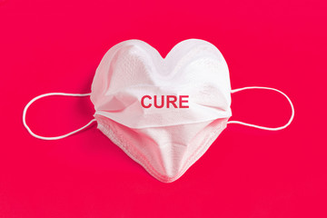 Surgical mask in the form of heart over colorful background