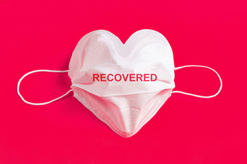 Surgical mask in the form of heart over colorful background