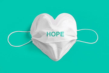 Surgical mask in the form of heart over colorful background