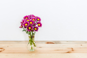 Beautiful red flowers in a vase, on a wooden background, interior decoration, background, isolate, inspiration, spring and gift