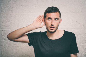 Overhears a man, tries to listen.
