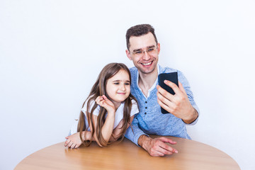dad and daughter selfie or video chat over the Internet, with friends, relatives, online communication, remote communication