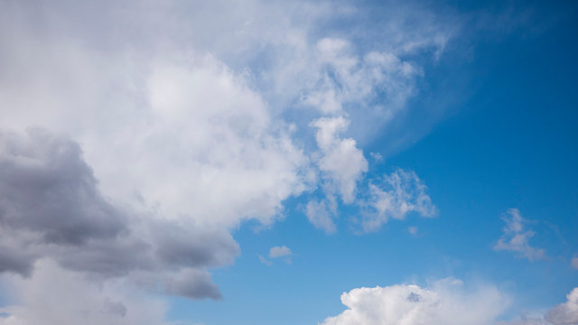 white clouds on a huge blue sky background © Yahor Shylau 
