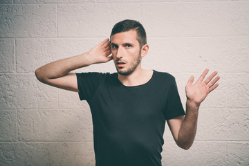 Overhears a man, tries to listen.