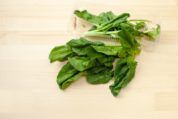 Fresh spinach leaves on a wooden background