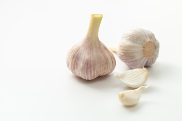 Young garlic and segments on a white background