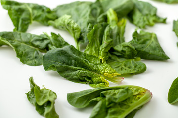 Fresh spinach leaves on a white background