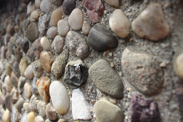 Pebbles cemented in a wall. 
