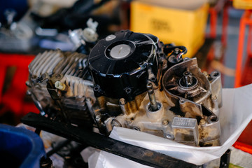 The motorcycle's engine is serviced or repaired by a mechanic.	