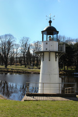 A small but detailed copy of a lighthouse in a public park. One of the landmarks of Riga city.