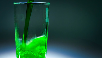A tall tall glass of water. The drink is pouring into the glass