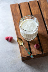 Fermented drink kefir in a glass jar on a light background. Probiotic cold fermented dairy drink.