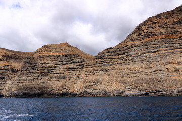 Fototapeta na wymiar Rocky cliffs on the shore on the coast of La Gomera Island, Canary Islands in Spain