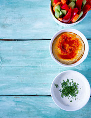 fresh vegetables, saur cream dip and hummus isolated on white