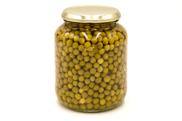 Green peas in a glass jar isolated