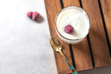 Fermented drink kefir in a glass jar on a light background. Probiotic cold fermented dairy drink.