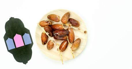 Table top view aerial image of decorations Ramadan Kareem holiday background.Flat lay date with  arabic lantern paper cut.Halal meal set for fasting is obligatory for Muslim on white wooden backdrop.