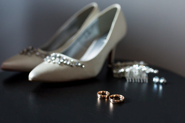 Beautiful details of the wedding day - shoes, accessories and wedding rings