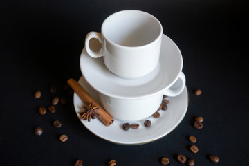 Large, medium, small cups for coffee against a dark background.