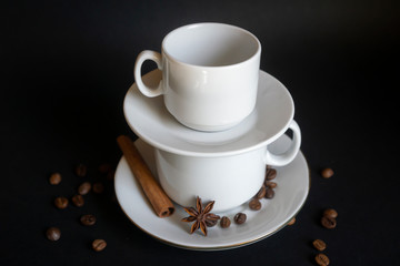 Large, medium, small cups for coffee against a dark background.