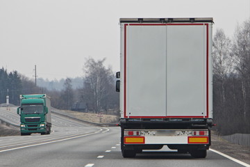 Trucks with on highway road at spring day, commercial transportation