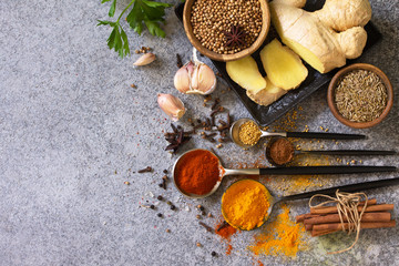 Set of Indian spices and herbs selection on a stone table. Top view flat lay background. Copy space.