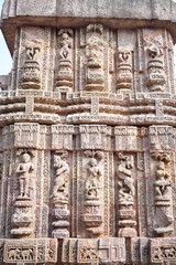 beautifully carved sculpture on a stone wall of konark sun temple.