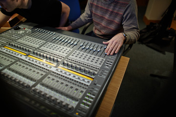 Audio engineer working at a professional sound mixing console
