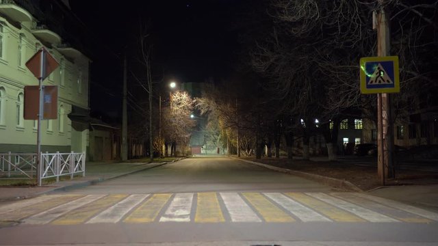 Simferopol empty city streets with street lights at night in autumn.