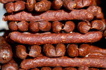 Close up of red pepper dried sausages on farmer market for sale