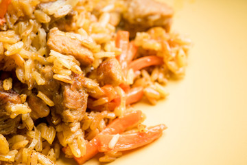 Traditional Uzbekistan pilaf on the rustic background. Selective focus. Shallow depth of field.
